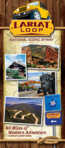 Front cover of Lariat Loop National Scenic Byway brochure with wooden background, pictures of local attractions and 40 Miles of Western Adventure.