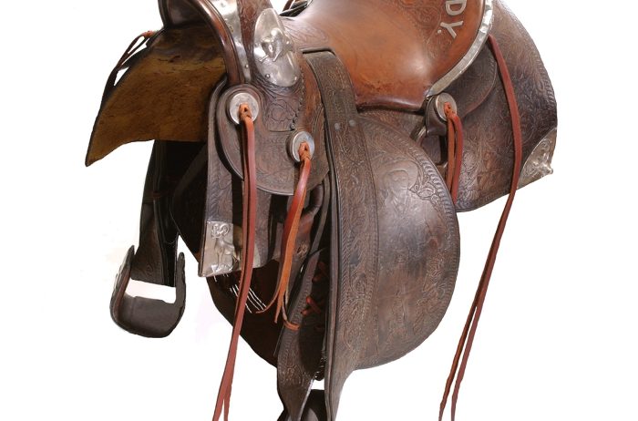 A saddle used by Buffalo Bill isolated on a white background.