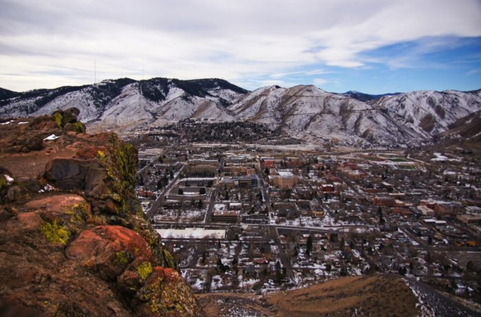 View of the town of Golden, Colorado in winter with snowy mountains in the distance.