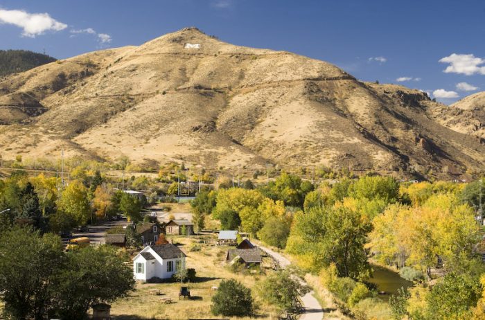 View of Clear Creek History Park in Golden, Colorado during autumn with many trees turning yellow.