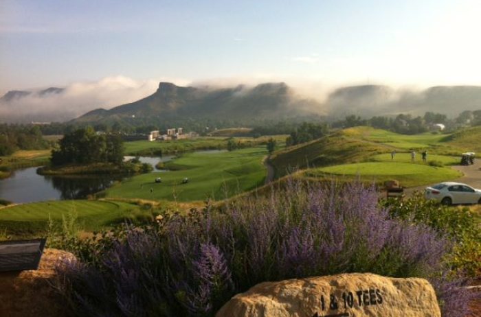View of Fossil Trace Golf Club in Golden, Colorado with foggy mountains in the distance.
