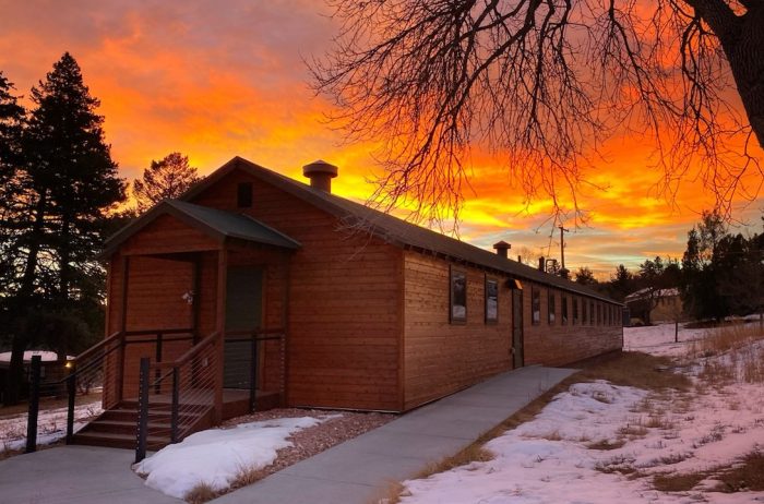 Red building at sunset with beautiful orange sky in Colorado.
